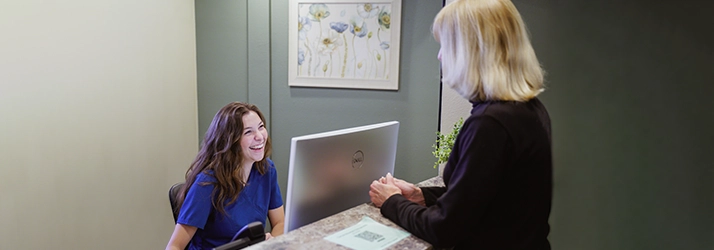 Front Desk Staff Meeting With Patient