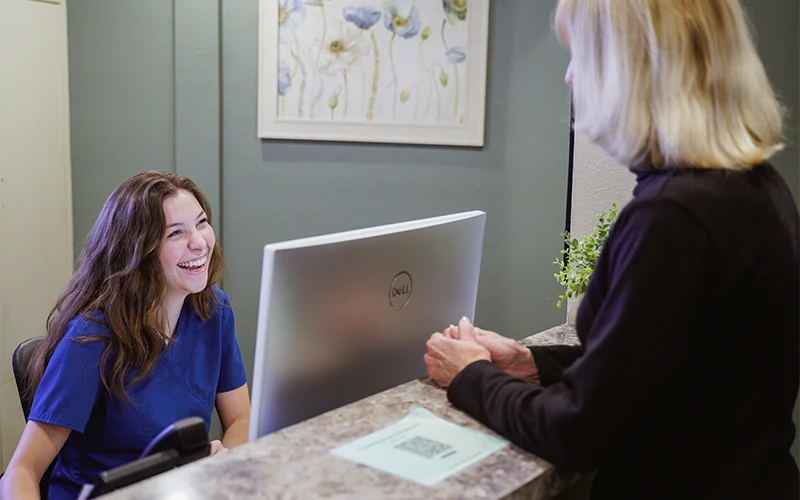 Staff Member At Reception Desk
