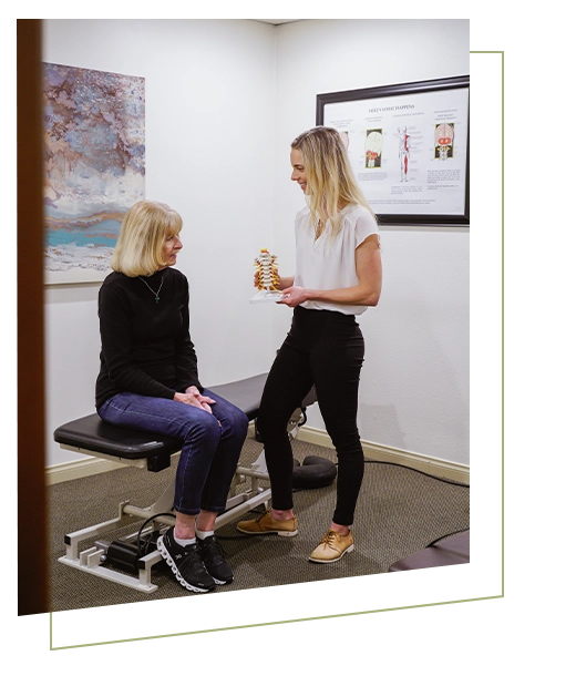 Chiropractor Chloé Lightner Consulting With Patient