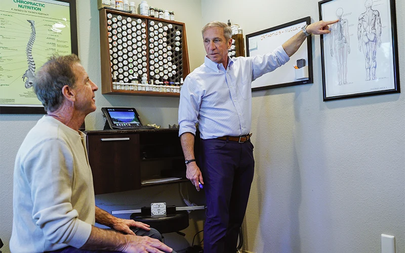 Chiropractor Dan Spinato Meeting With Patient