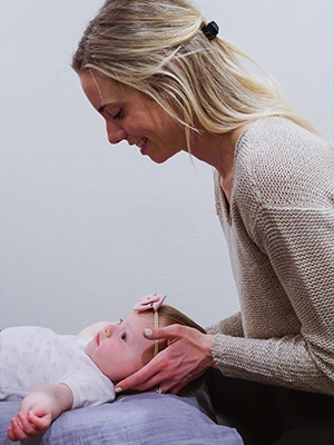 Chiropractor San Diego CA Chloé Lightner Adjusting A Pediatric Patient