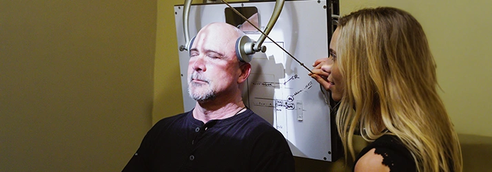 Chiropractor San Diego CA Chloé Lightner Using Machine To Provide NUCCA Care